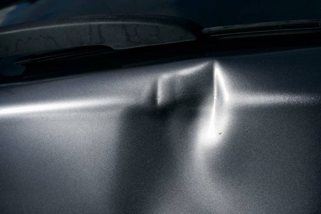 Grey Car With Dent In Door